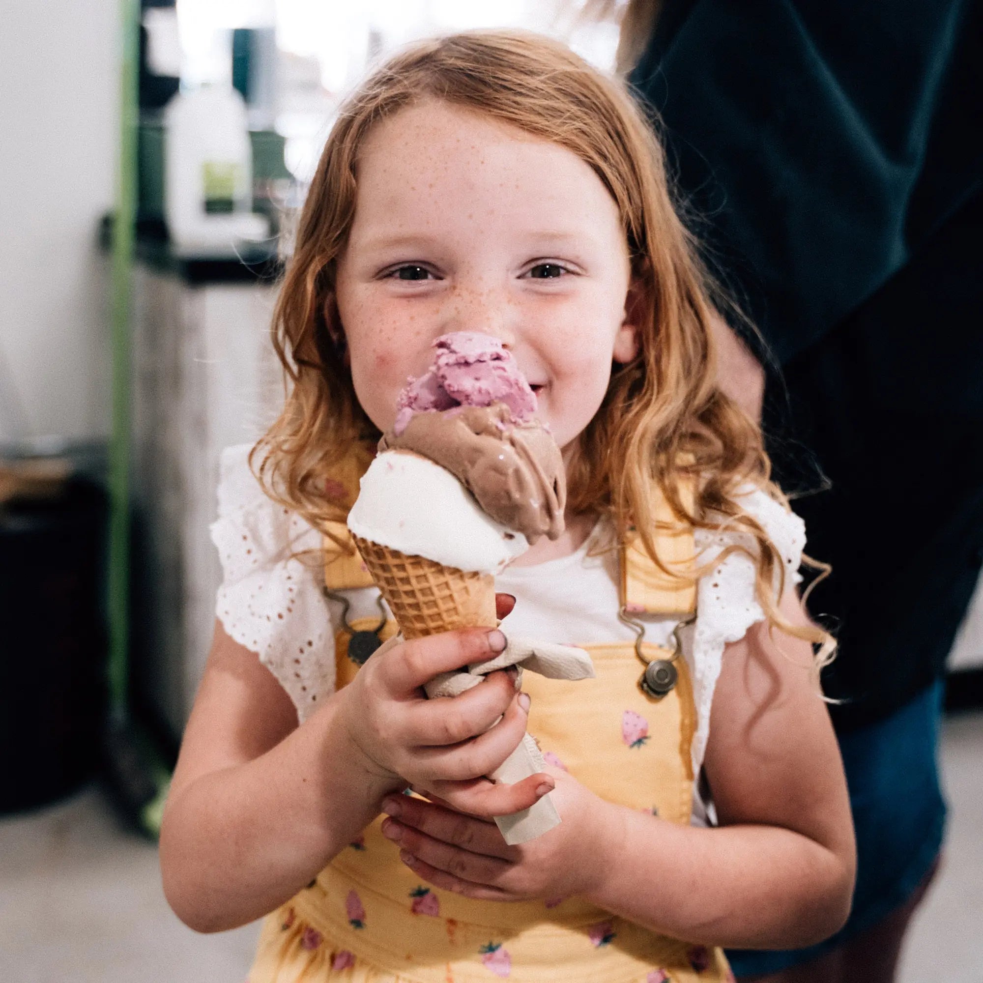 A young girl eating ice cream at the Market Hall at Harvest the Fleurieu.